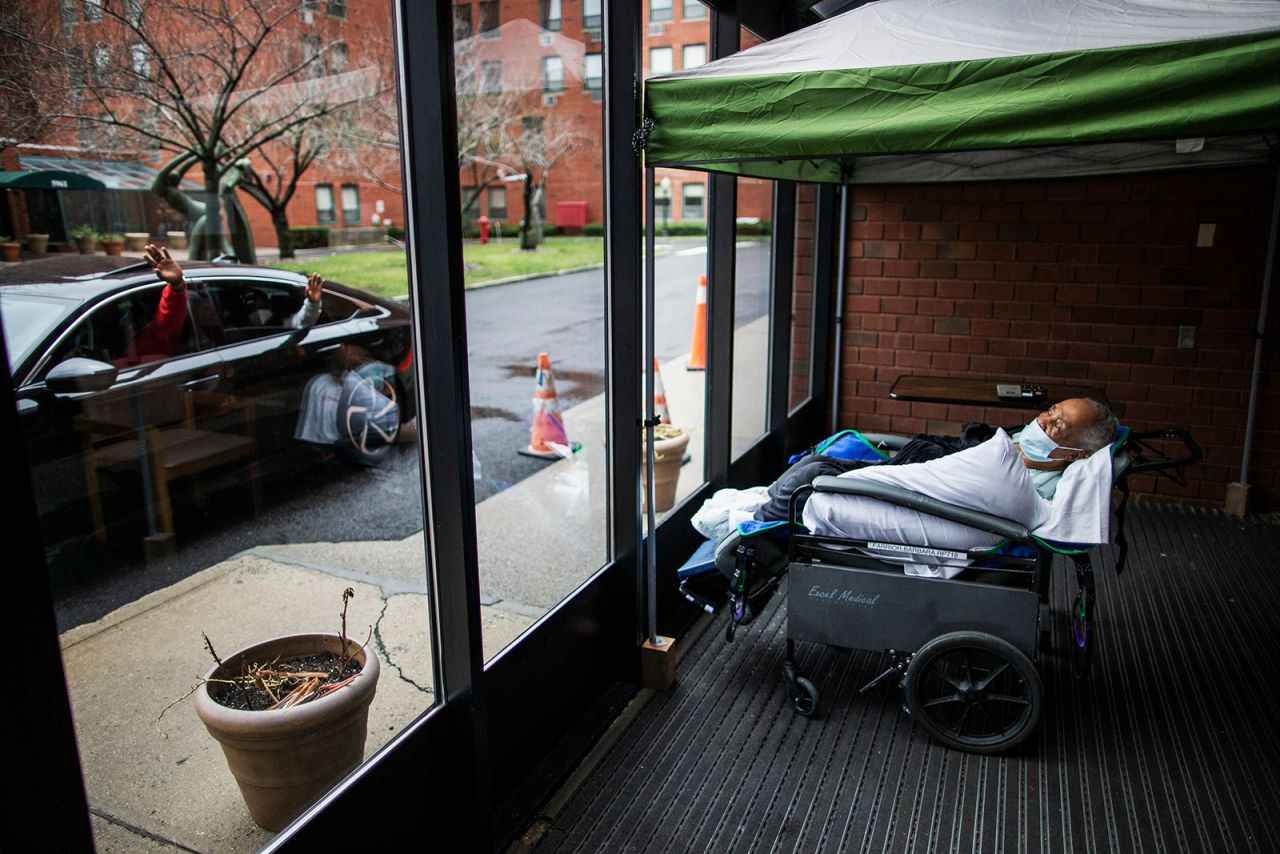 Family members wave goodbye to Barbara Farrior, 85, after visiting her at her nursing home in New York on Thanksgiving Day. The Hebrew Home at Riverdale was featuring drive-up visits so that families could connect with their loved ones <a href="https://www.cnn.com/2020/11/25/world/gallery/holidays-coronavirus-pandemic/index.html" target="_blank">celebrating the holiday</a> alone.