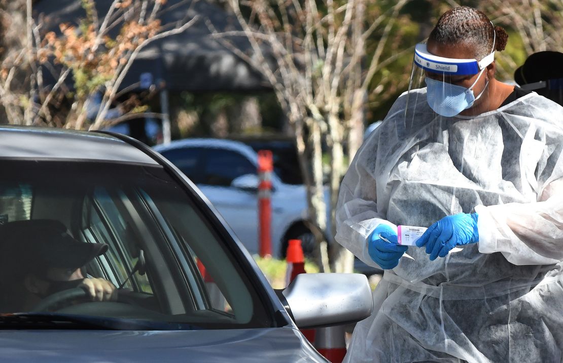 A health worker prepares to perform a nasal swab sample at a Covid-19 rapid testing site at Barnett Park in Orlando.