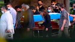 The coffin with the remains of late Argentine football legend Diego Armando Maradona is carried by his family and friends at the Jardin Bella Vista cemetery, in Buenos Aires province, on November 26, 2020. - Argentine football legend Diego Maradona -who died of a heart attack on the eve, at the age of 60- will be laid to rest where his parents have been buried. (Photo by RONALDO SCHEMIDT / AFP) (Photo by RONALDO SCHEMIDT/AFP via Getty Images)
