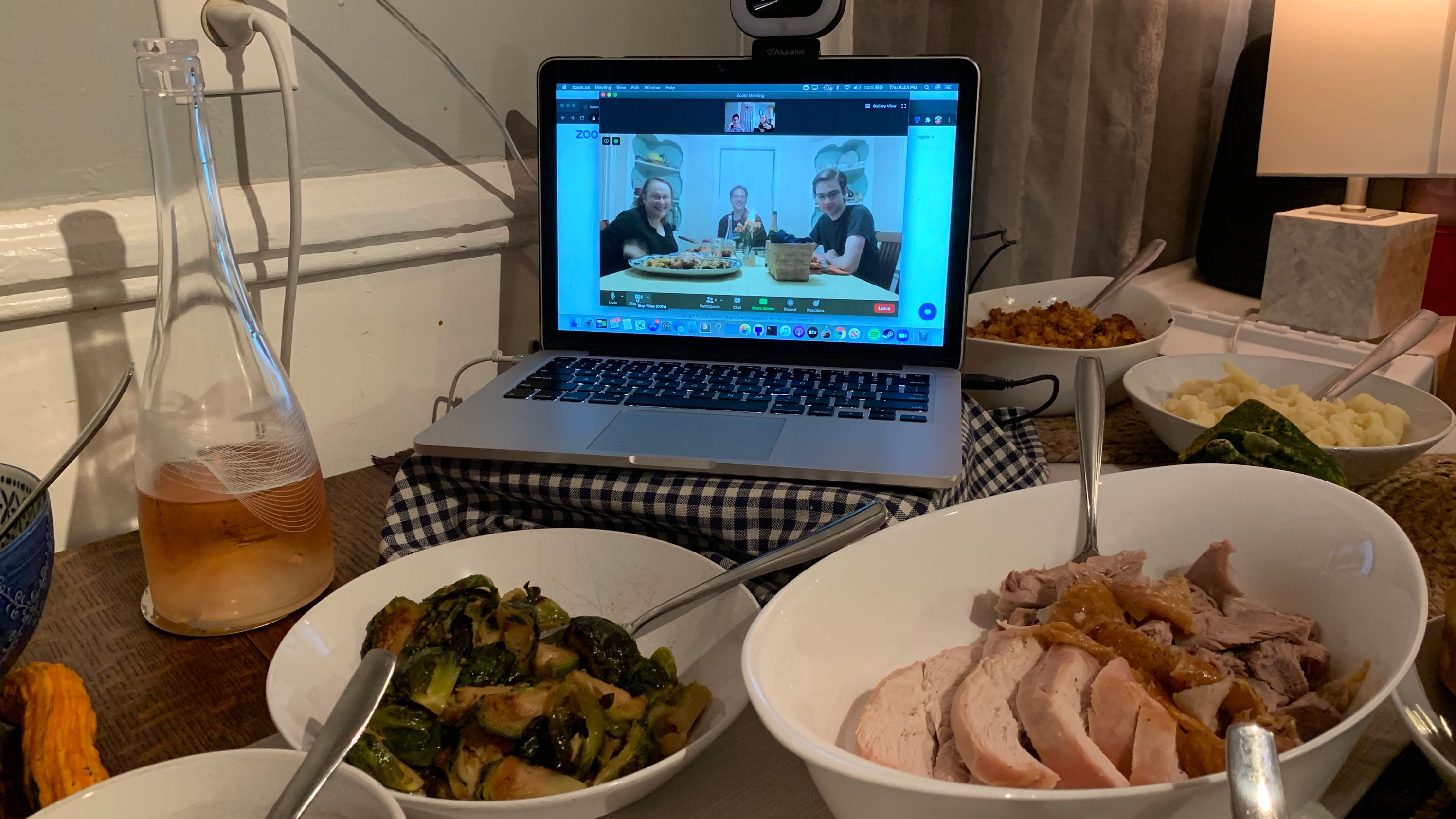 The Kingsley family celebrates the Thanksgiving meal from three homes via videoconference. 