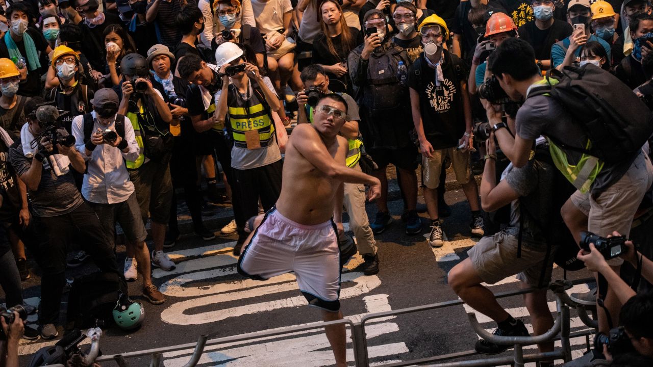 Protester Pun Ho-chiu throws an egg at the police headquarters in Hong Kong on June 21, 2019.