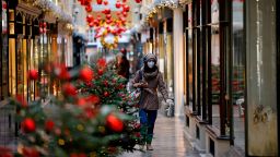 A pedestrian wearing a protective face covering walks past Christmas-themed window displays inside Burlington Arcade in London on November 27, as life under a second coronavirus lockdown continues in England.