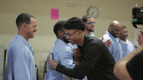 Sy Green embraces prisoners he met while participating in the reading group.