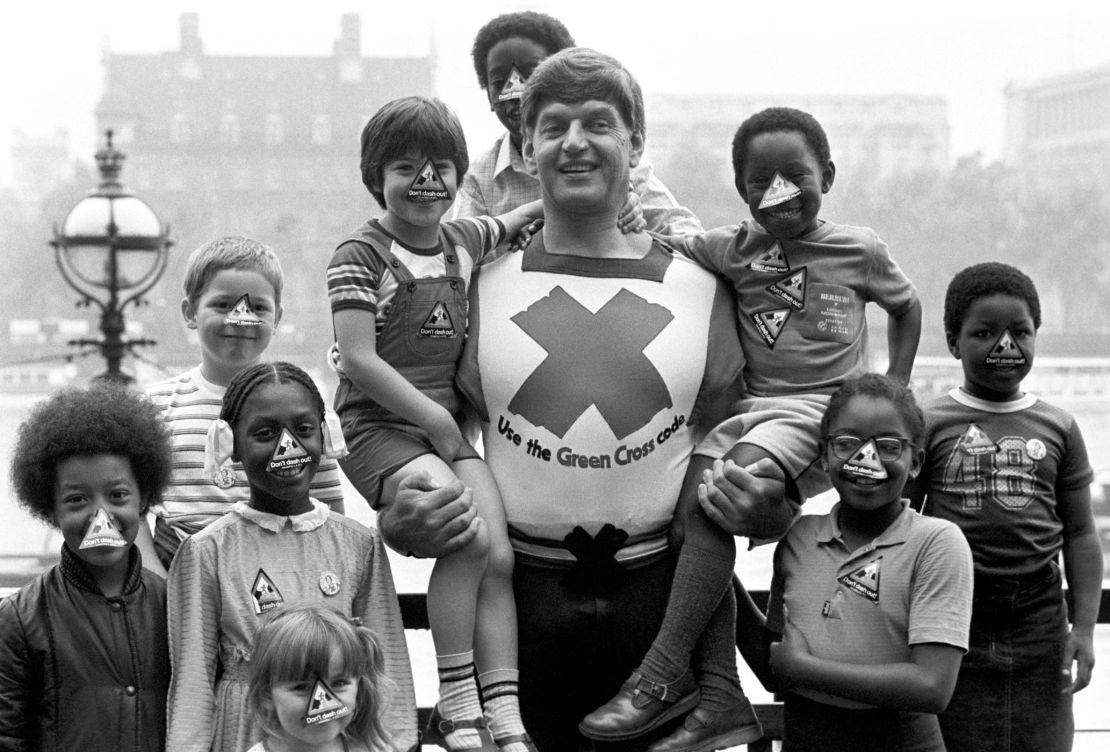 Dave Prowse in his role as the Green Cross Code Man, with students from Lambeth Johanna Primary School in London.