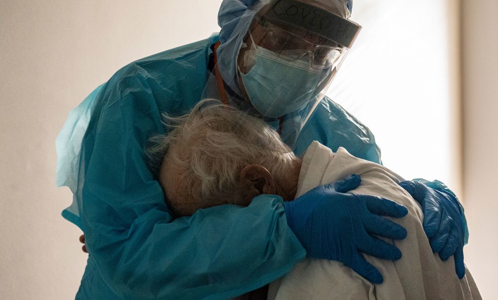 Dr. Joseph Varon comforts a patient on Thanksgiving Day in the Covid-19 intensive care unit at the United Memorial Medical Center in Houston.