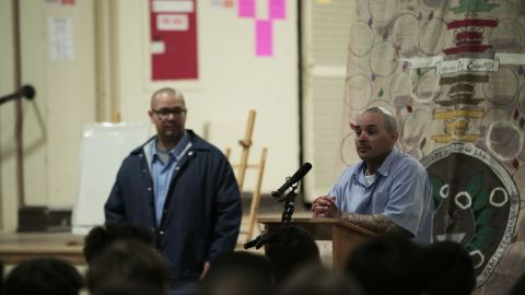 Alfredo Ortega speaks at a podium.