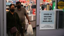 A sign on the entrance to a pharmacy reads "Covid-19 Vaccine Not Yet Available", November 23, 2020 in Burbank, California. - British drugs group AstraZeneca and the University of Oxford said they will seek regulatory approval for their coronavirus vaccine, adding to hopes that a post-pandemic economy could be in the offing following similar announcements by Pfizer/BioNTech and Moderna. (Photo by Robyn Beck / AFP) (Photo by ROBYN BECK/AFP via Getty Images)