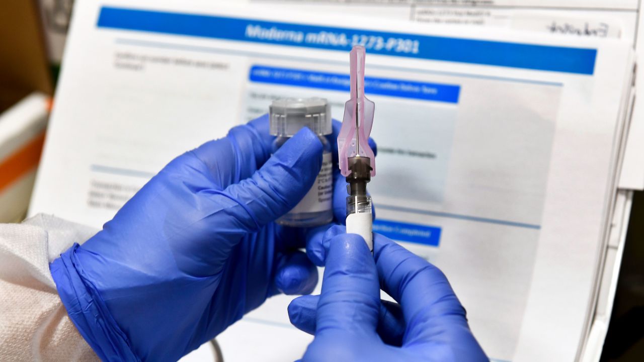 FILE - In this July 27, 2020, file photo, nurse Kathe Olmstead prepares a shot that is part of a possible COVID-19 vaccine, developed by the National Institutes of Health and Moderna Inc., in Binghamton, N.Y. Moderna Inc. says it will ask U.S. and European regulators to allow emergency use of its COVID-19 vaccine as new study results confirm the shots offer strong protection. (AP Photo/Hans Pennink, File)