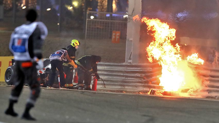 A steward reacts as officials put out a fire on Haas F1's French driver Romain Grosjean car following a crash during the Bahrain Formula One Grand Prix at the Bahrain International Circuit in the city of Sakhir on November 29, 2020. (Photo by TOLGA BOZOGLU / POOL / AFP) (Photo by TOLGA BOZOGLU/POOL/AFP via Getty Images)
