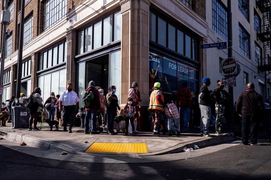 Hundreds of homeless people wait in line to receive food from the Los Angeles Mission on the day before Thanksgiving.