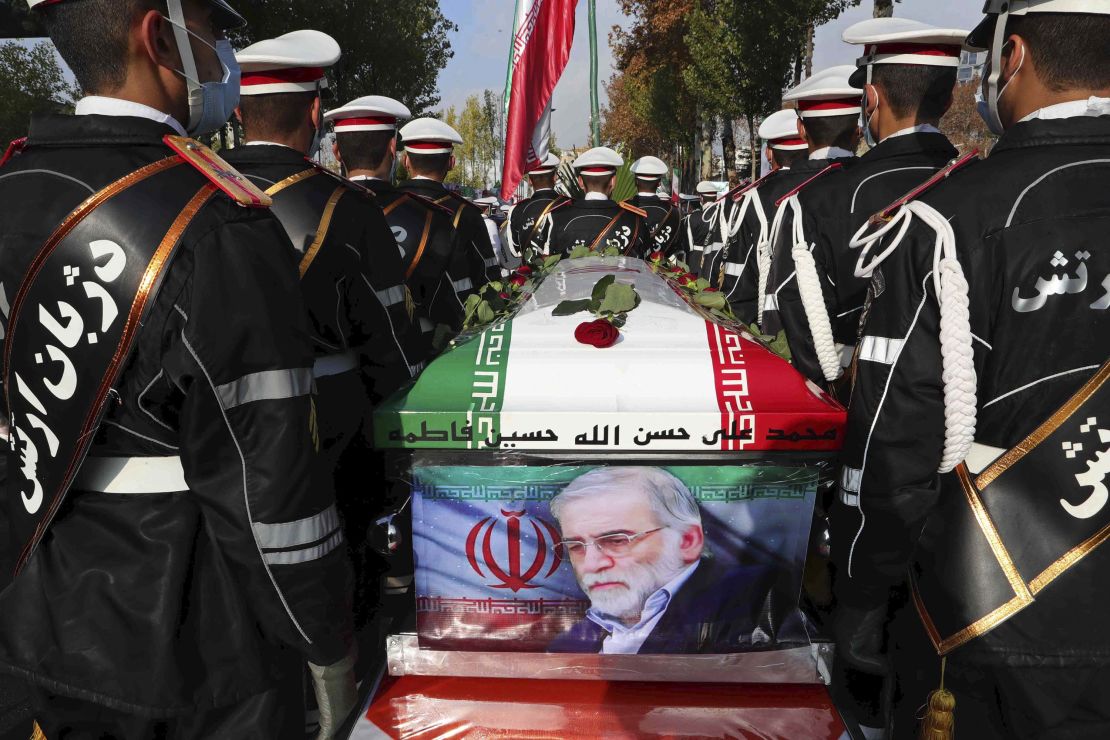 Military personnel stand next to the flag-covered coffin of Mohsen Fakhrizadeh during his funeral in Tehran, Iran, Monday, Nov. 30. Iran claims it has evidence that Israel was behind the attacks.