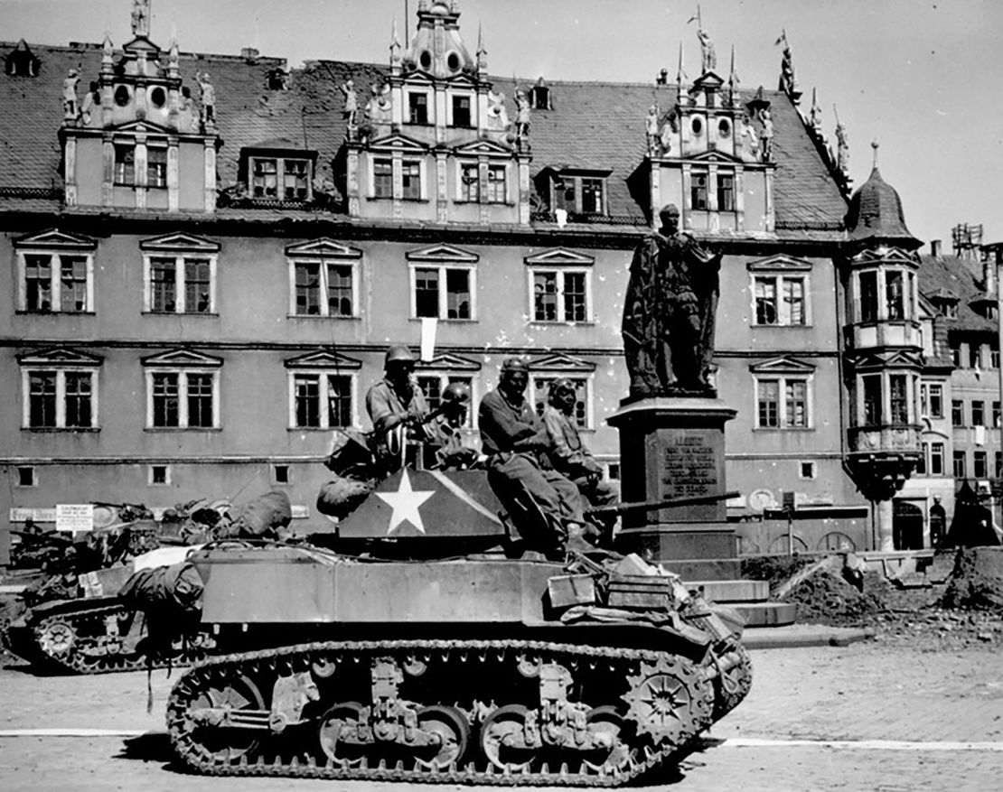 Tank crews from the 761st Tank Battalion await orders to clean out scattered Nazi machine gun nests in Coburg, Germany, April 25, 1945. 