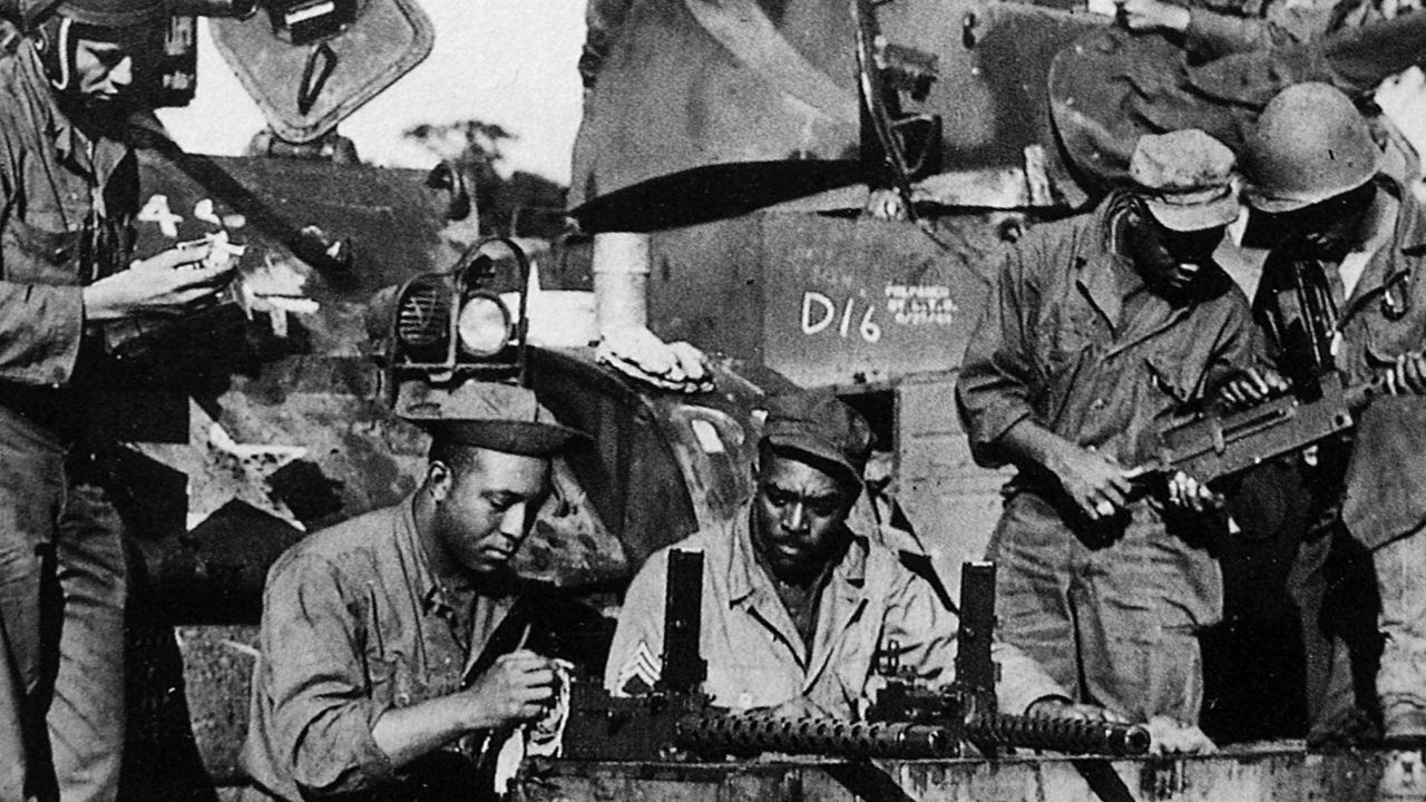 Soldiers from Dog Company of the 761st Tank Battalion--the first African-American tank battalion to go into battle. check equipment before leaving England for combat in France in the fall of 1944. 