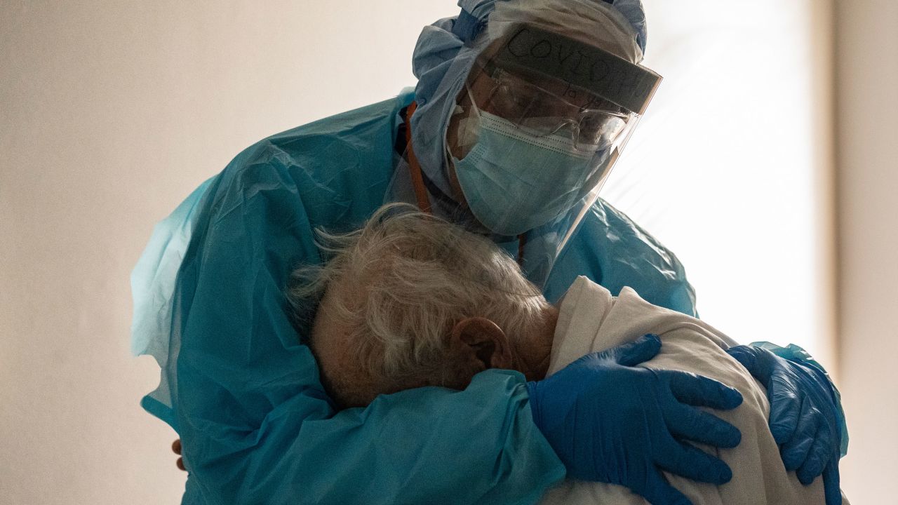 Dr. Joseph Varon comforts a patient in the COVID-19 intensive care unit during Thanksgiving at the United Memorial Medical Center in Houston, Texas.