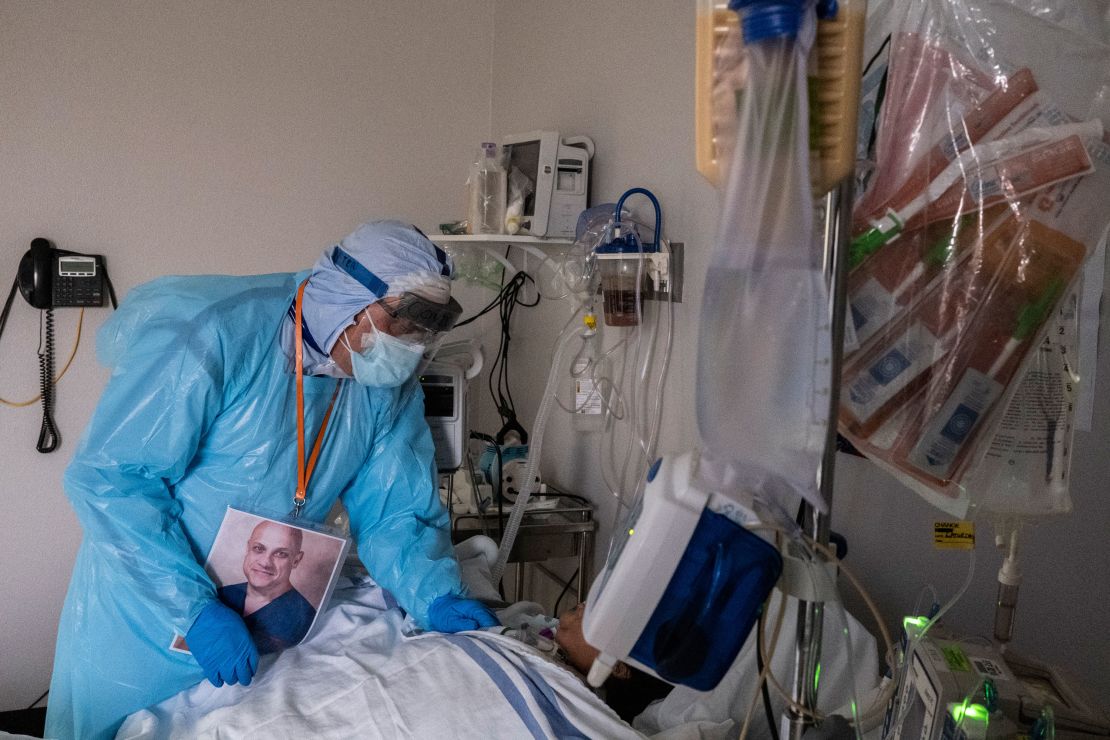 Dr. Joseph Varon talks to a patient in the ICU unit during the Thanksgiving holiday.