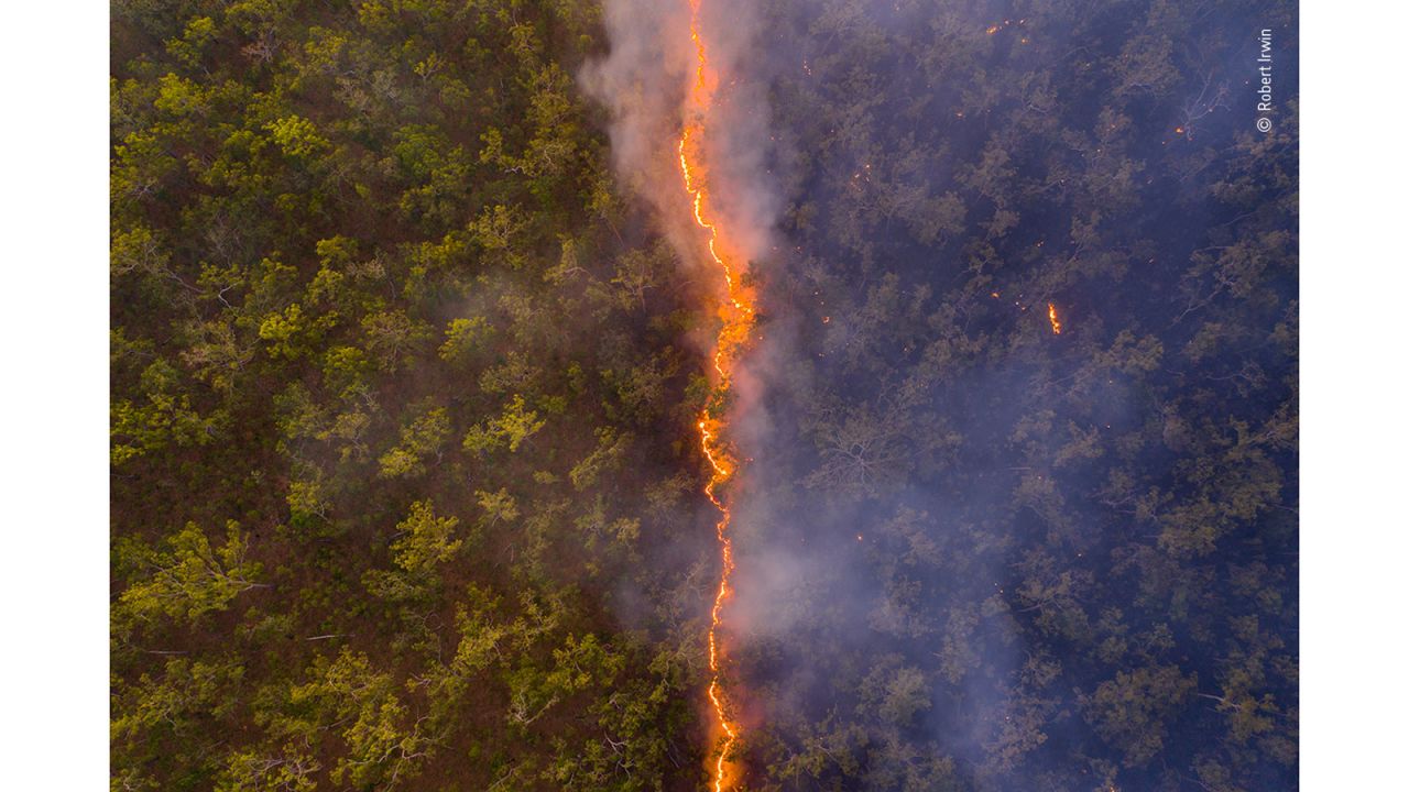 A fire line leaves a trail of destruction through woodland near the border of the Steve Irwin Wildlife Reserve in Cape York, Queensland, Australia.