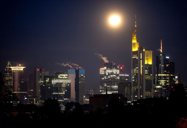 The moon shines over the banking district in Frankfurt, Germany.