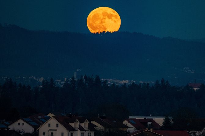 The full moon rises behind the Bavarian Forest in Passau, Germany.