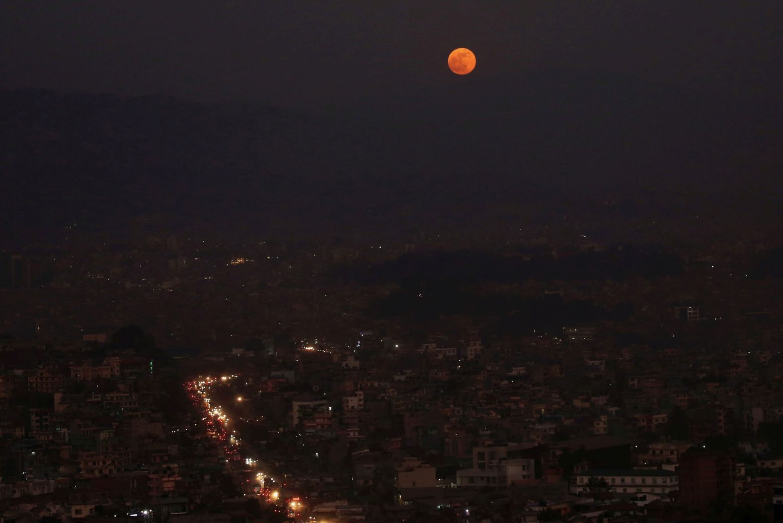 The full moon is shown above the valley in Kathmandu, Nepal, November 30.