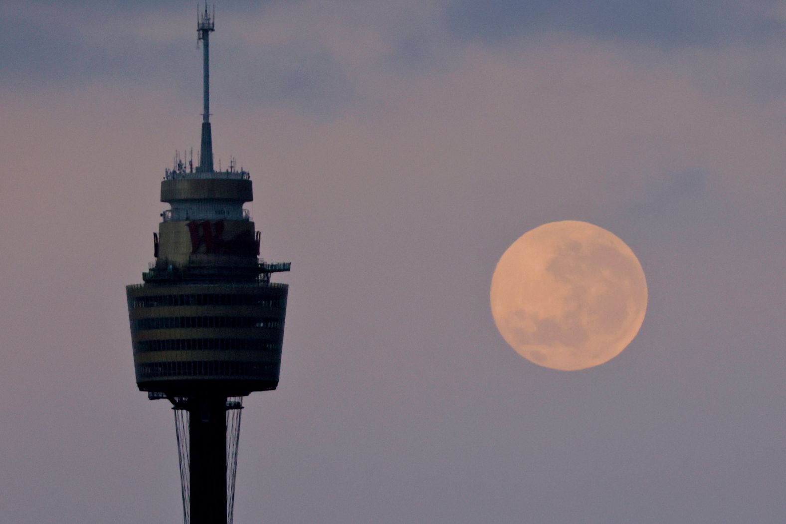 The moon sets behind the Sydney Tower on December 1 in Sydney.