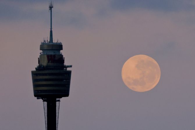 The moon sets behind the Sydney Tower on December 1 in Sydney.