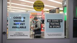 A sign on the entrance to a pharmacy reads "Covid-19 Vaccine Not Yet Available", November 23, 2020 in Burbank, California. - British drugs group AstraZeneca and the University of Oxford said they will seek regulatory approval for their coronavirus vaccine, adding to hopes that a post-pandemic economy could be in the offing following similar announcements by Pfizer/BioNTech and Moderna. (Photo by Robyn Beck/AFP/Getty Images)