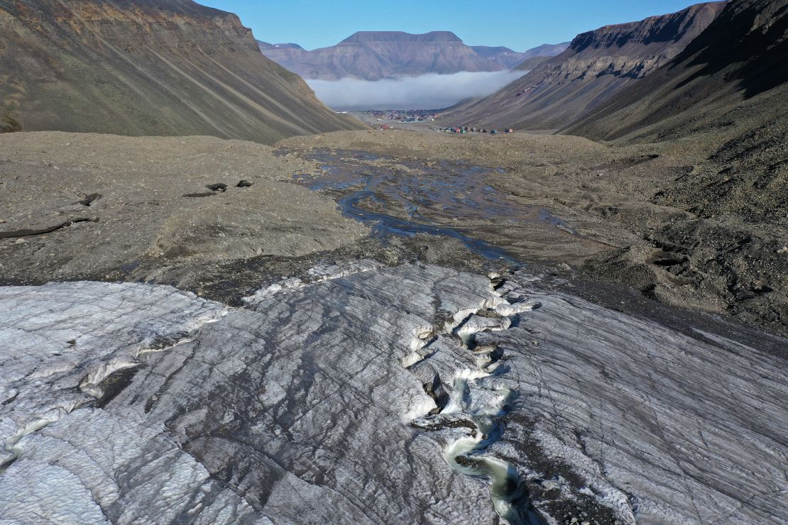 In this aerial view from a drone, taken in July 2020, meltwater carves a winding channel through the melting Longyearbreen glacier during a summer heat wave near Longyearbyen, Norway.
