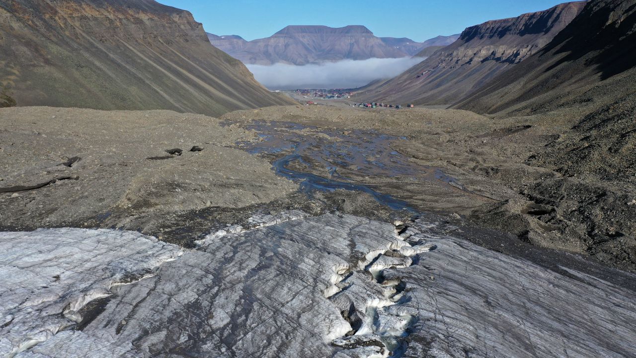 In this aerial view from a drone, taken in July 2020, meltwater carves a winding channel through the melting Longyearbreen glacier during a summer heat wave near Longyearbyen, Norway.