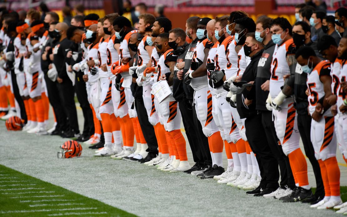 Cincinnati Bengals players and coaches wear face masks while standing for the national anthem before a game November 22, 2020, against the Washington Football Team.
