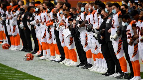 Cincinnati Bengals players and coaches wear face masks while standing for the national anthem before a game November 22, 2020, against the Washington Football Team.