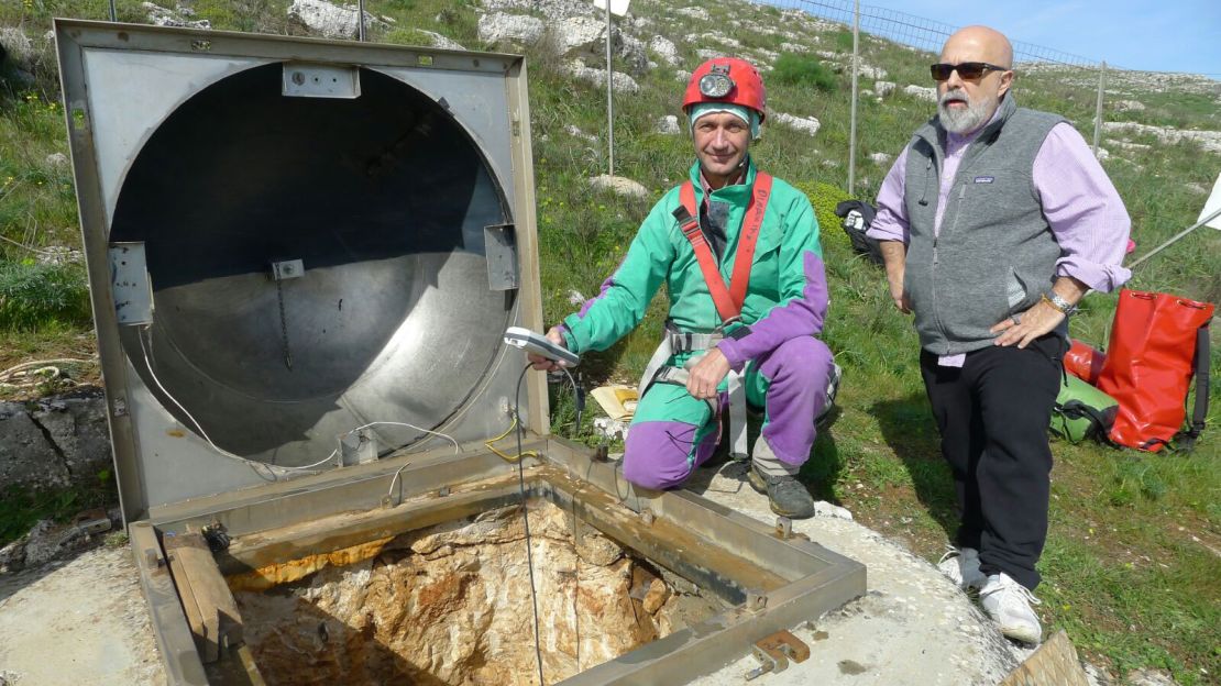 Shown here are researchers at the entrance to the cave system where the fossilized skeleton is located. 