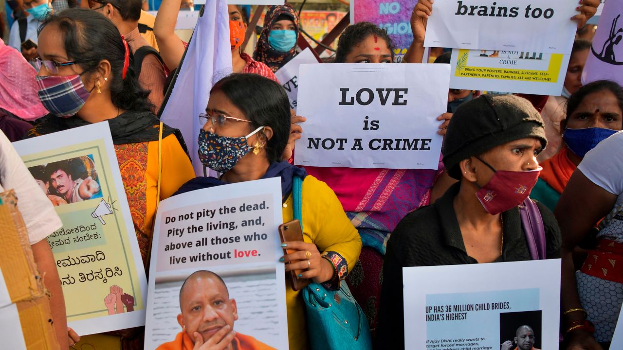 Activists in Bangalore on December 1 hold placards during a demonstration condemning the  proposed passing of laws against "Love Jihad."