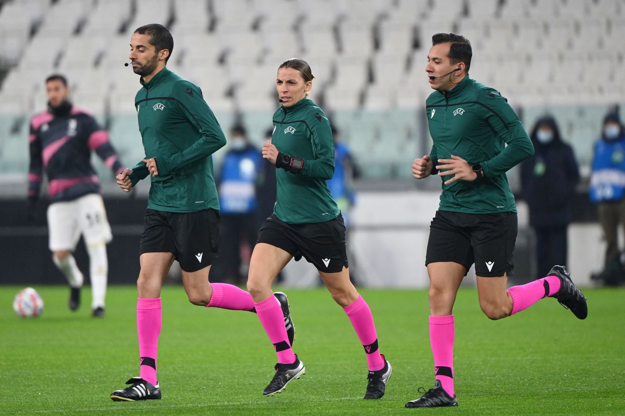 Soccer referee Stephanie Frappert warms up with assistant referees Hicham Zakrani, left, and Mehdi Rahmouni before a UEFA Champions League match in Turin, Italy, on Tuesday, December 2. Frappert became <a href="https://www.cnn.com/2020/12/02/football/stephanie-frappart-ucl-juventus-dynamo-kiev-spt-intl/index.html" target="_blank">the first woman to referee a men's Champions League match.</a>