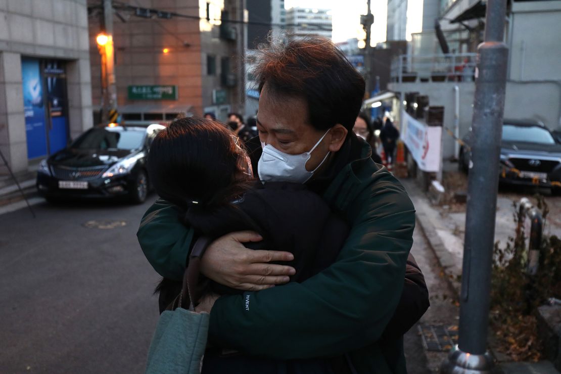 A father hugs on her daughter taking the college entrance exam amid the coronavirus pandemic on December 3, 2020 in Seoul, South Korea. 