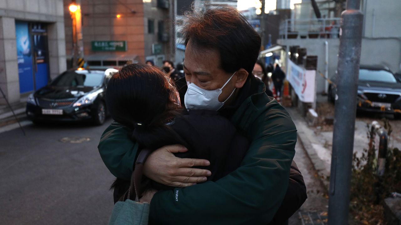 A father hugs on her daughter taking the college entrance exam amid the coronavirus pandemic on December 3, 2020 in Seoul, South Korea. 
