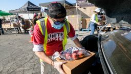 November 14, 2020, Los Angeles, California, USA: A volunteer loads food into the trunk of a vehicle during a ''Let's Feed L.A. County'' food distribution during the COVID19 crisis, Saturday, Nov. 14, 2020, in Burbank, Calif. (Credit Image: © Ringo Chiu/ZUMA Wire)