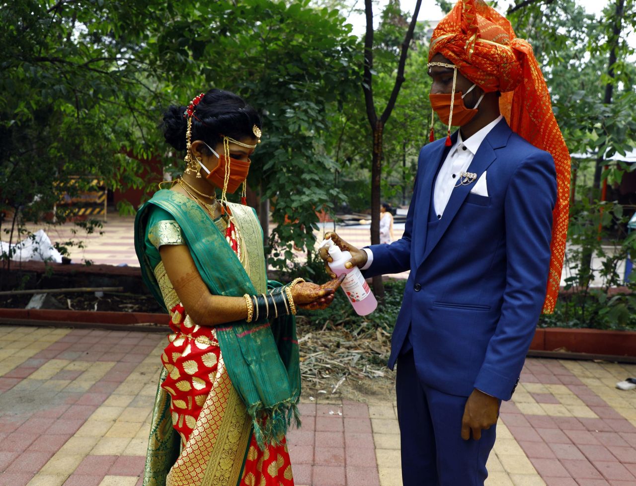 A couple use hand sanitizer following their wedding ceremony in Pune, India, in May.