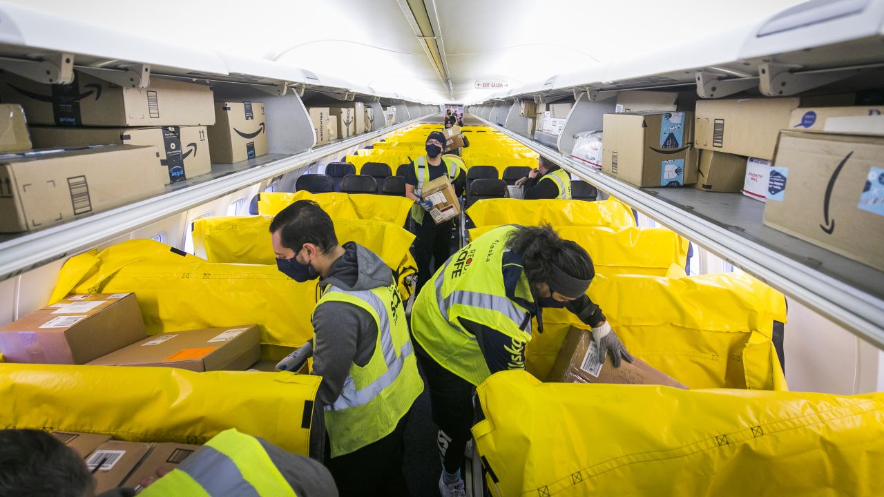 Alaska Air Cargo's Load Agents insure packages are stowed safely in the passenger cabin of their retrofitted 737-900.