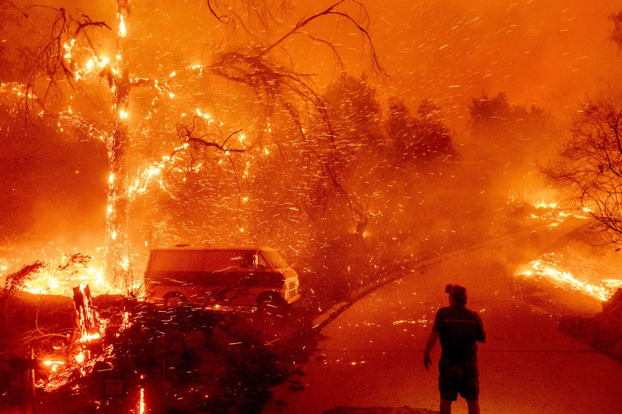 Bruce McDougal watches embers fly over his property as the Bond Fire burns in Orange County, California, on Thursday, December 3. <a href="https://www.cnn.com/2020/12/03/weather/southern-california-edison-power-outage/index.html" target="_blank">The fire</a> has prompted mandatory evacuations in several areas near the Silverado Canyon.