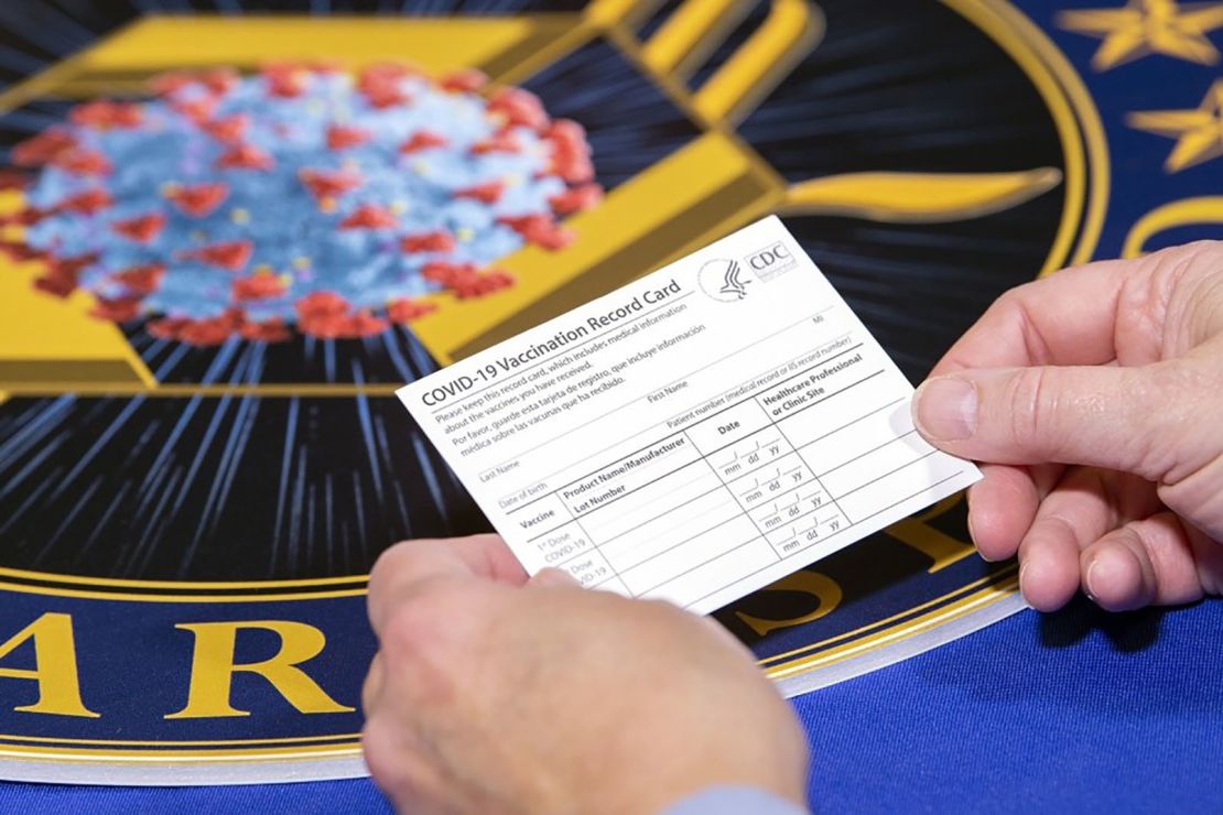 A Department of Health and Human Services employee holds a COVID-19 vaccine record card Nov. 13, 2020, in Washington D.C. The cards will be sent out as part of vaccination kits from Operation Warp Speed, which is an effort by several U.S. government components and public partnerships to facilitate the development, manufacturing and distribution of COVID-19 vaccines, therapeutics and diagnostics. (DoD photo by EJ Hersom)