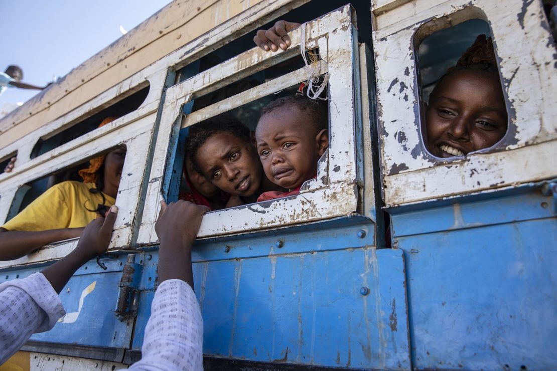 Tigray refugees who fled the conflict in northern Ethiopia ride a bus to a temporary shelter near the Sudan-Ethiopia border on Tuesday, December 1.