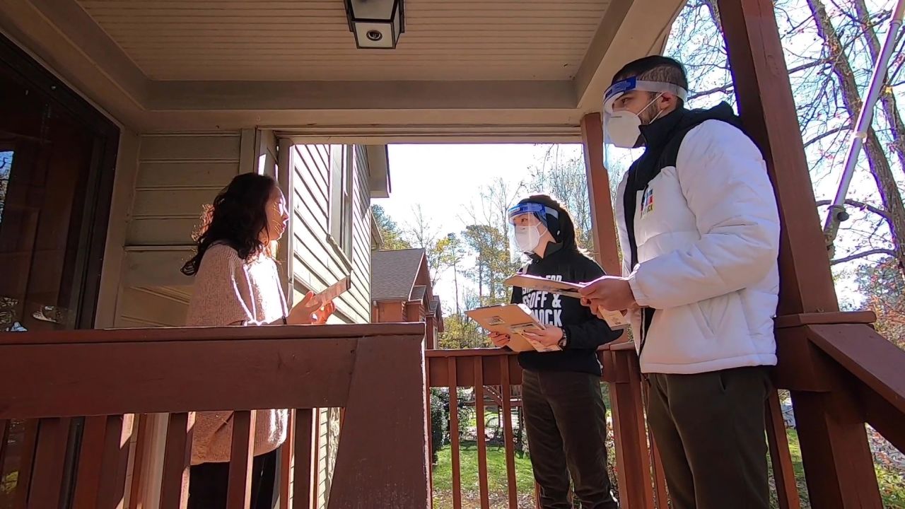 Volunteers Grace Pai and Syed Hussain speak with eligible AAPI voters outside of Atlanta, Georgia.
