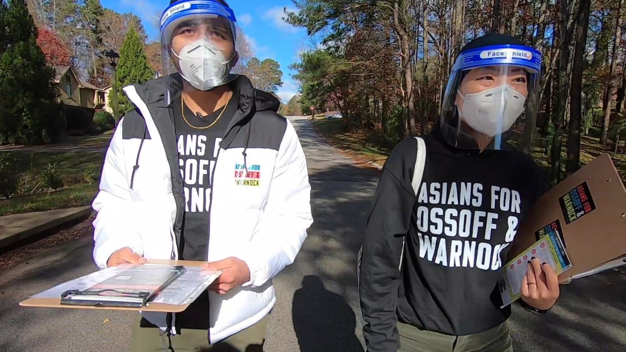 Volunteers Grace Pai and Syed Hussain go door to door to inform AAPI voters about Georgia's January runoff elections.