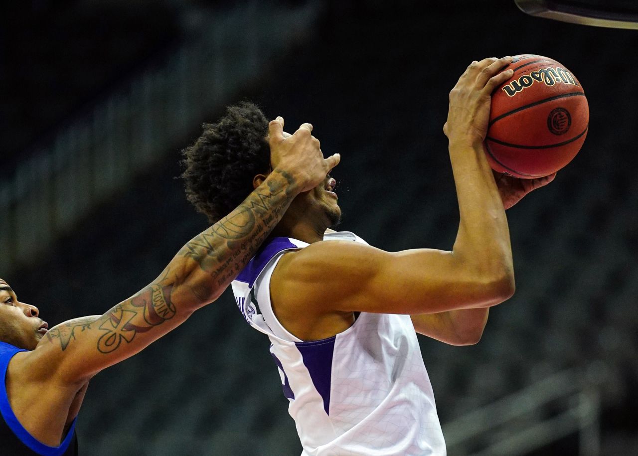 TCU's Chuck O'Bannon Jr. is fouled by Tulsa's Elijah Joiner during a college basketball game in Kansas City, Missouri, on Saturday, November 28.