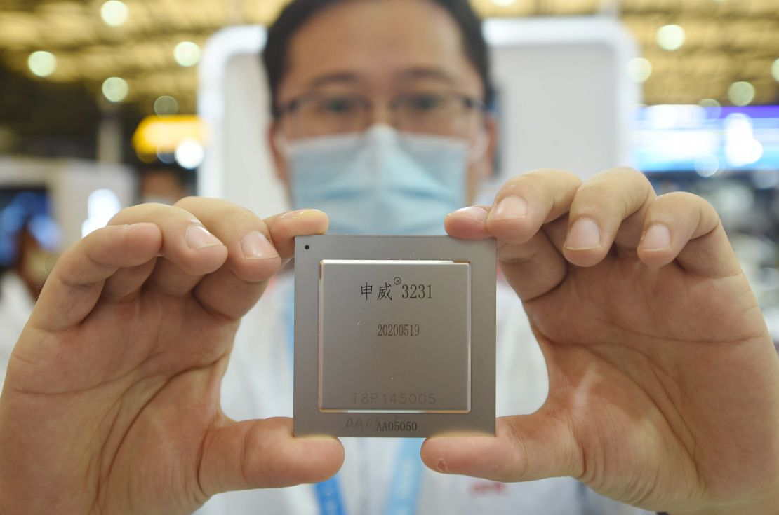 A SMIC employee shows off the latest home-made server chip at the China International Semiconductor Expo 2020. SMIC says its semiconductors are for civilian and commercial use, and that it has no relationship with the Chinese military.