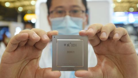 A SMIC employee shows off the latest home-made server chip at the China International Semiconductor Expo 2020. SMIC says its semiconductors are for civilian and commercial use, and that it has no relationship with the Chinese military.