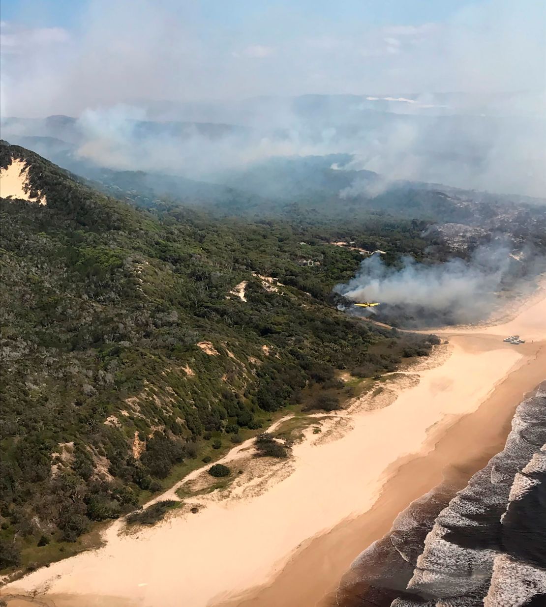 Smoke blows over hills and toward the ocean at Fraser Island, on Australia's east coast, where a fire has raged for six weeks.