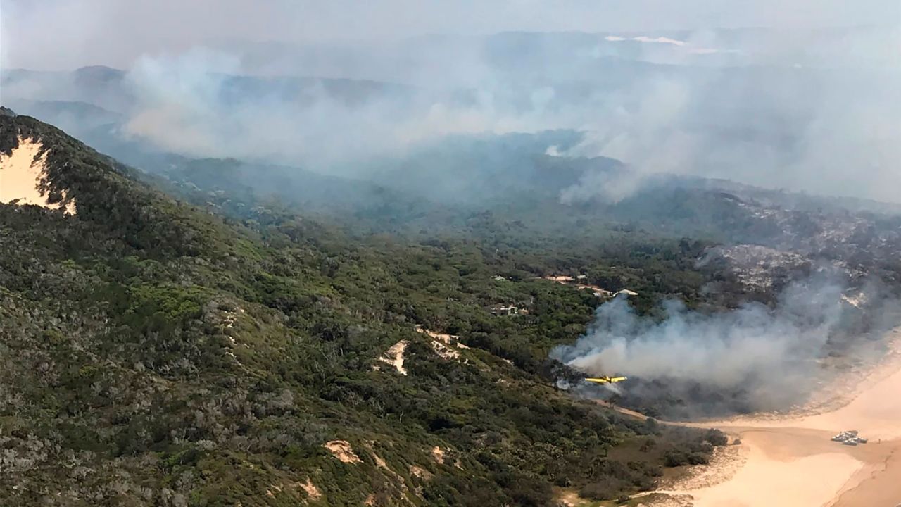 Smoke blows over hills and toward the ocean at Fraser Island, on Australia's east coast, where a fire has raged for six weeks.