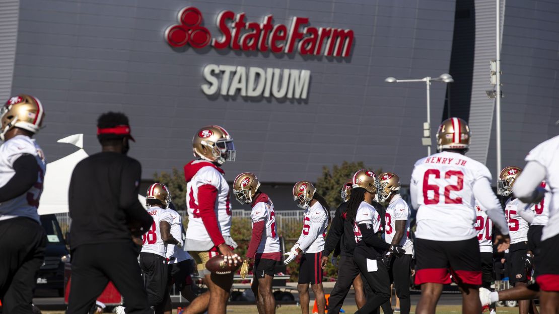 49ers players stretch during practice on December 3.