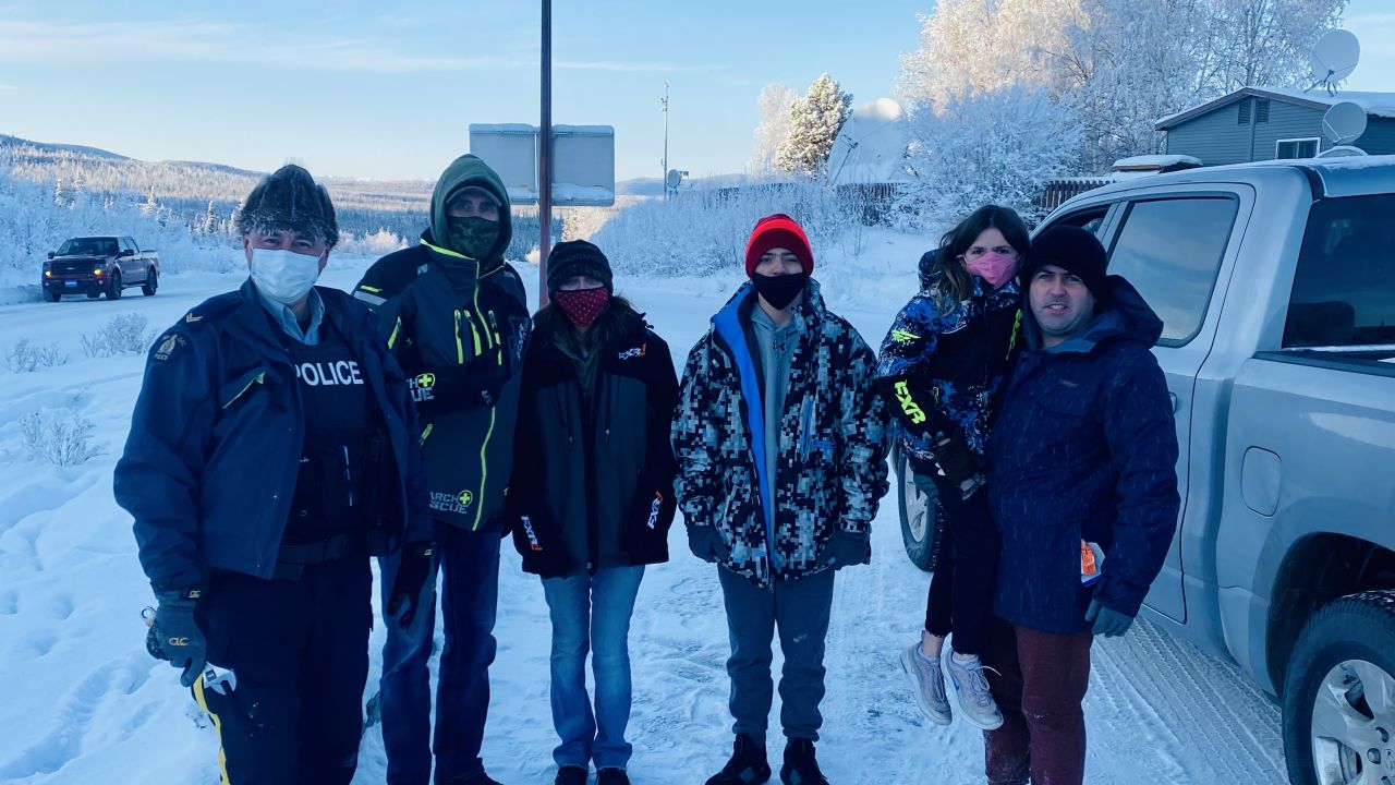 Reunited: RCMP Cpl. Robert Drapeau stands next to Gary Bath, Lynn Marchessault, Payton Marchessault, Rebecca Marchessault and Tim Marchessault (l to r) near the US-Canadian border crossing.